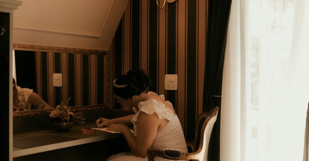 Woman organizing pregnancy planning notes in minimalist home setting