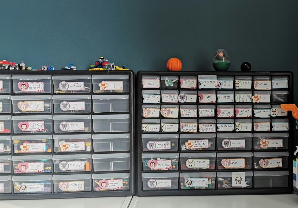 Clear stackable storage bins organizing toys in a nursery closet.