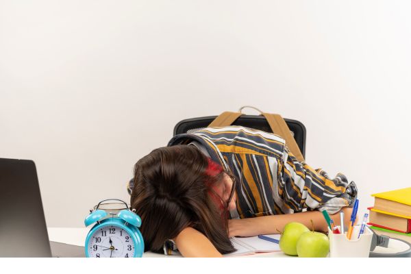 Tired mom on a desk by FlexyMamaHacks.com